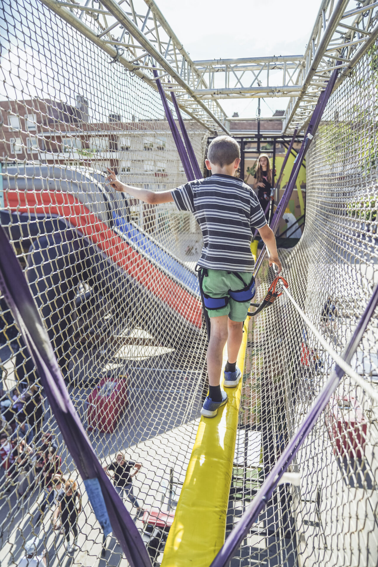 enfant traversant le pont de singe de la tour Indiana